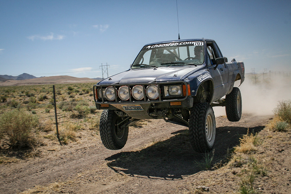 blue-toyota-pickup-long-travel-jump-off-road-desert.jpg